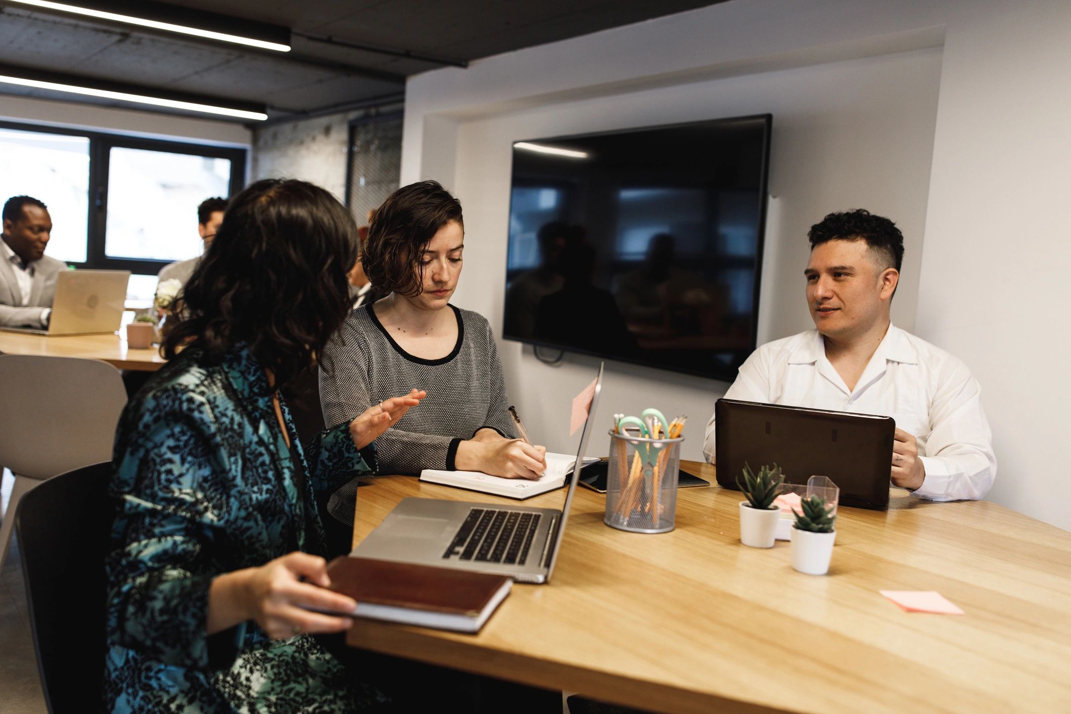 Editorial team meeting in a newsroom-style workspace