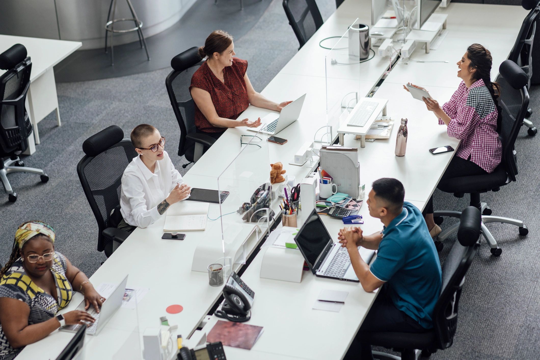 Newsroom team collaborating at desks